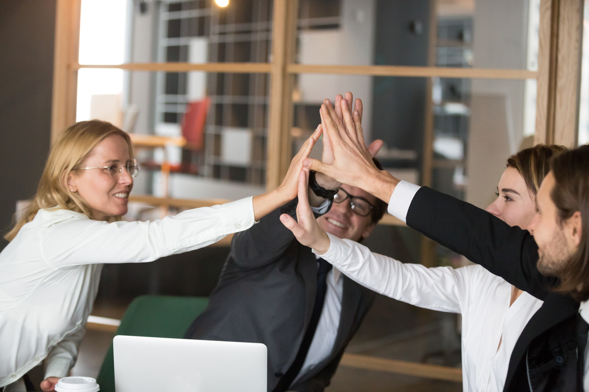 a team of men and women rejoices in completing their tasks