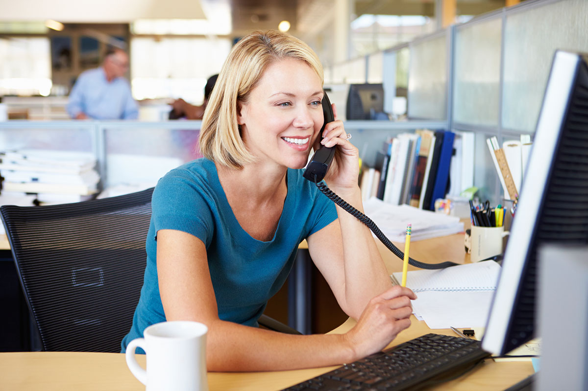 woman at work communicates with a client on the phone