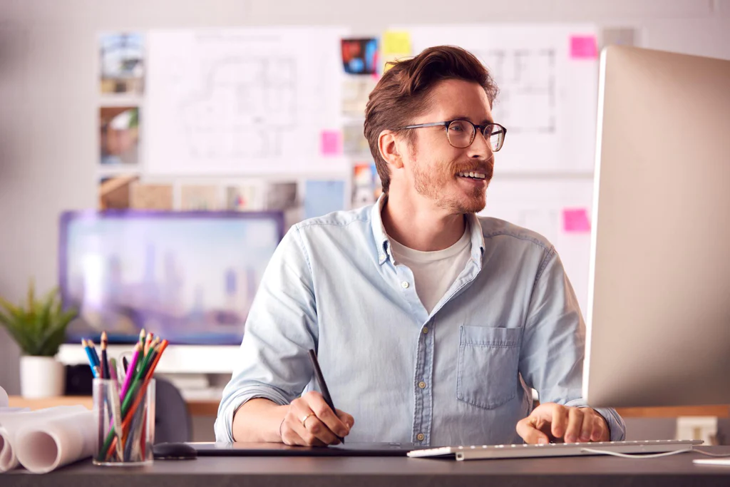 man working enthusiastically at the computer