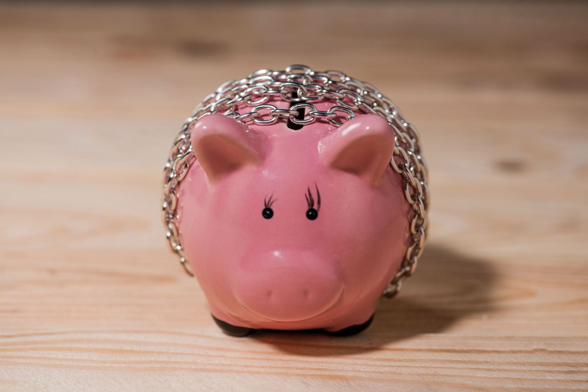 piggy bank chained with a chain